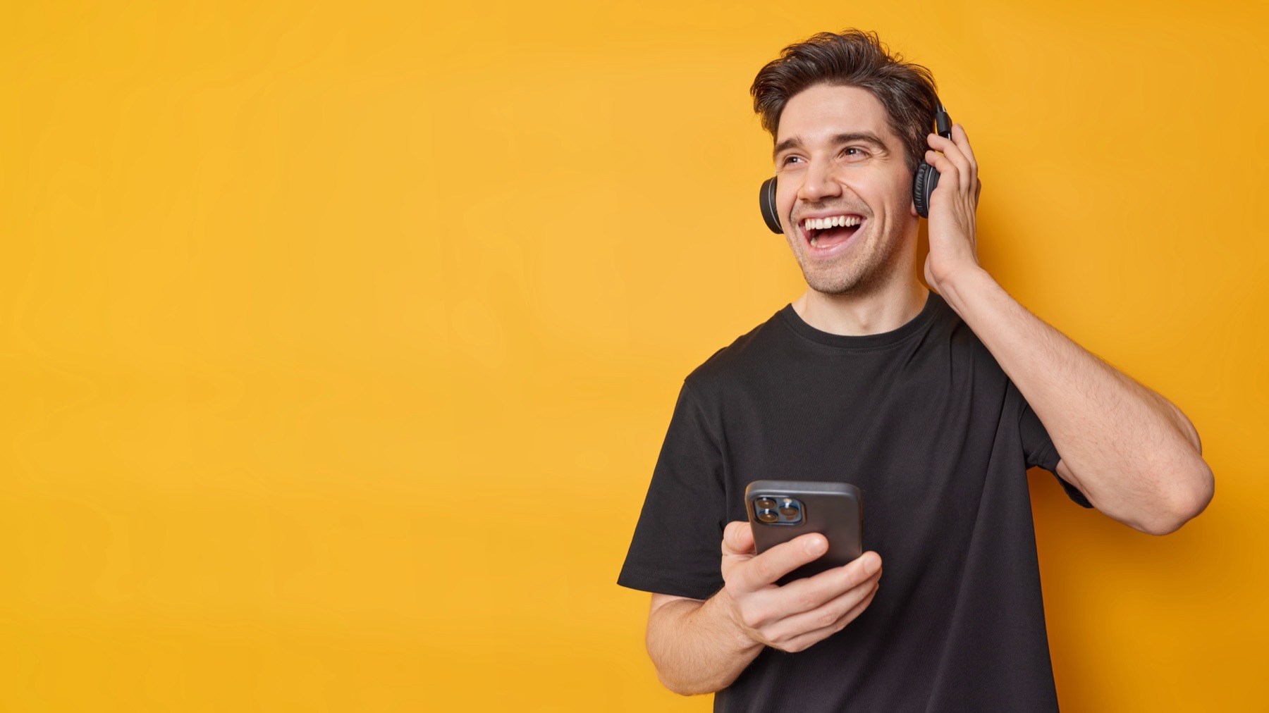 Hands holding a smartphone with a digital music library