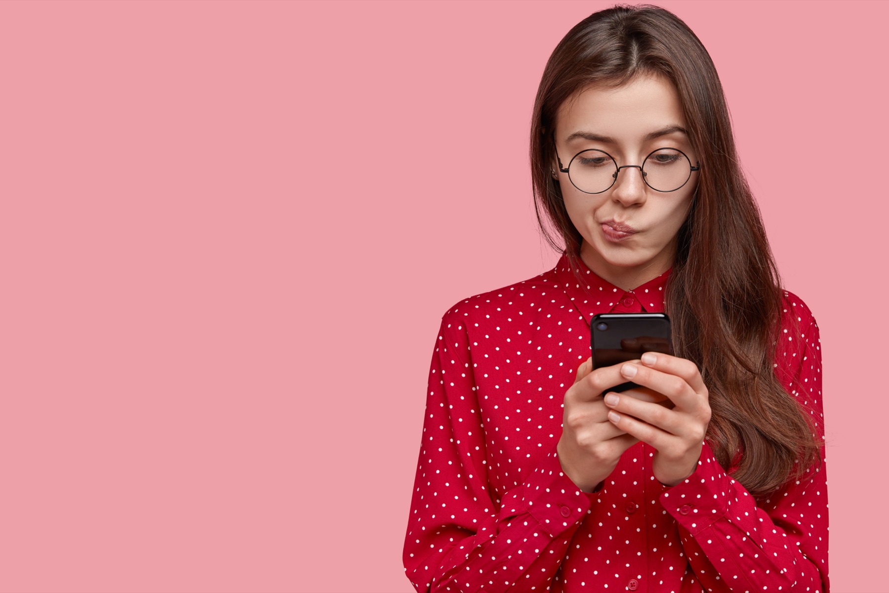 A smartphone showing a social media photo feed beside lines of HTML embed code on a screen