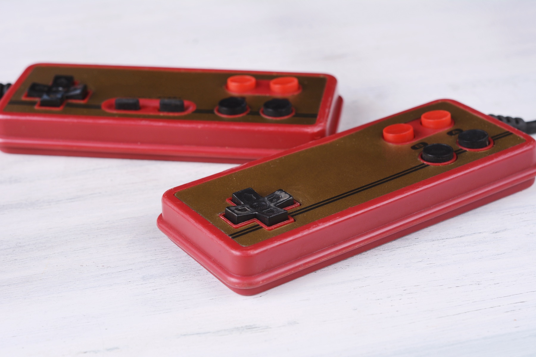 A retro game console cartridge connected to a circuit board, evoking 1990s console software