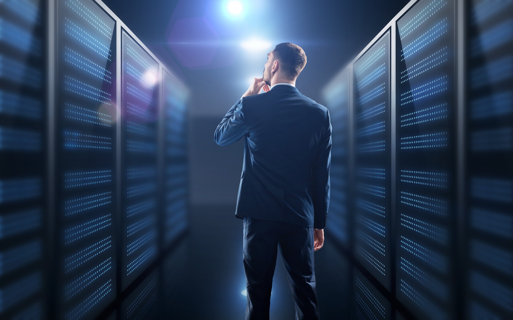 Server room corridor with rows of illuminated data servers