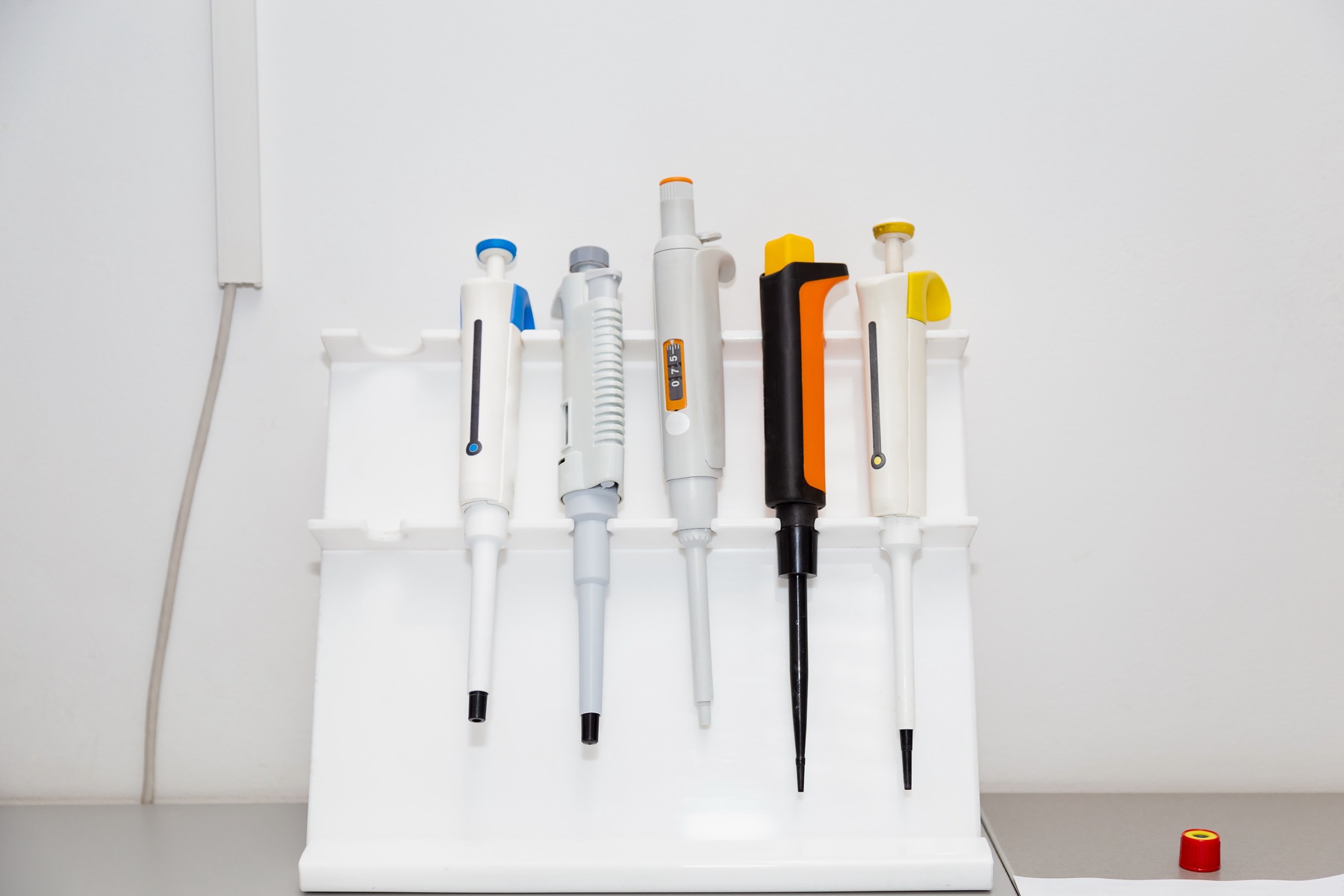 A scientist pipetting samples during preclinical drug research