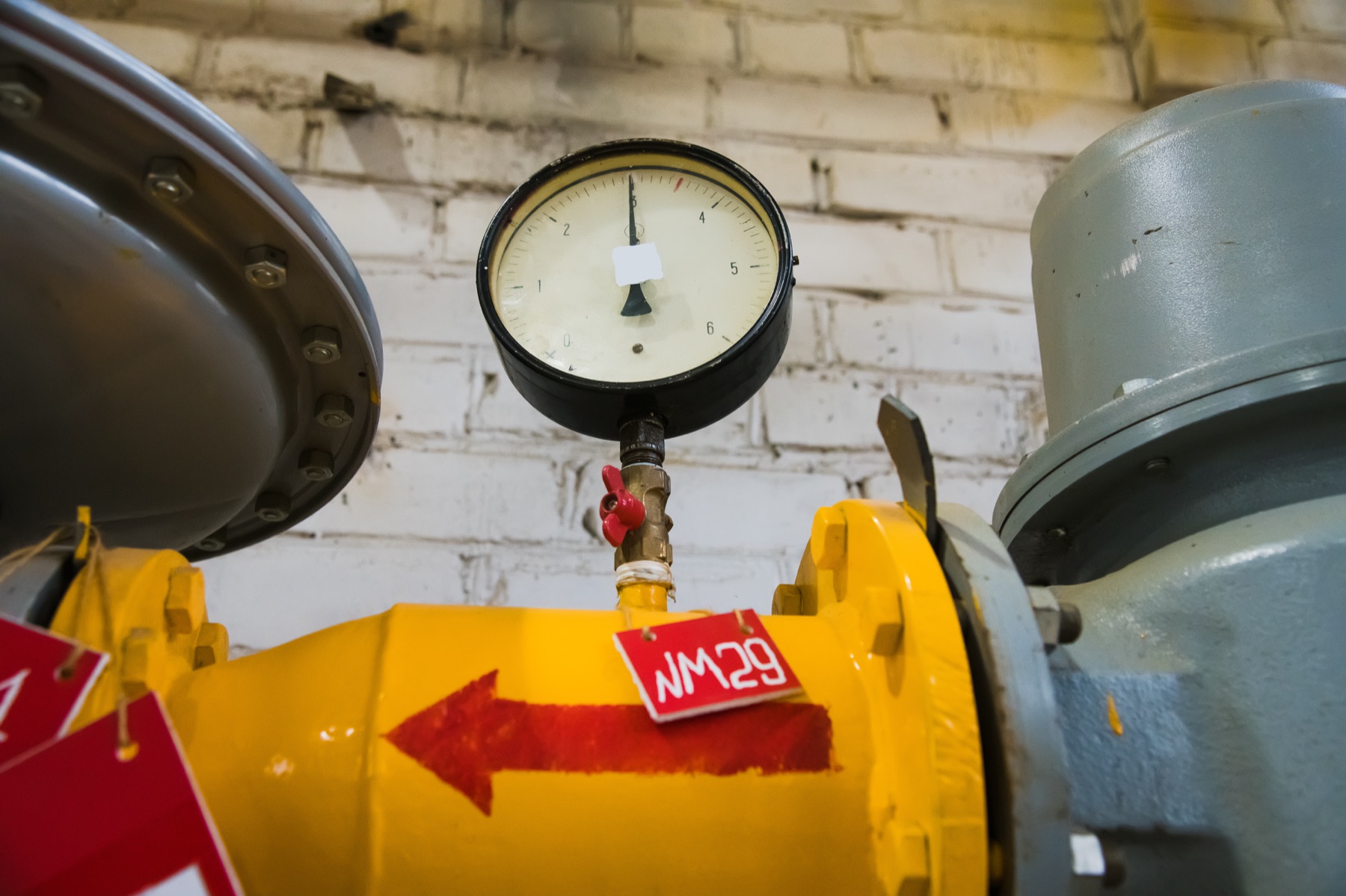 An industrial chemical reactor vessel with temperature and pressure gauges