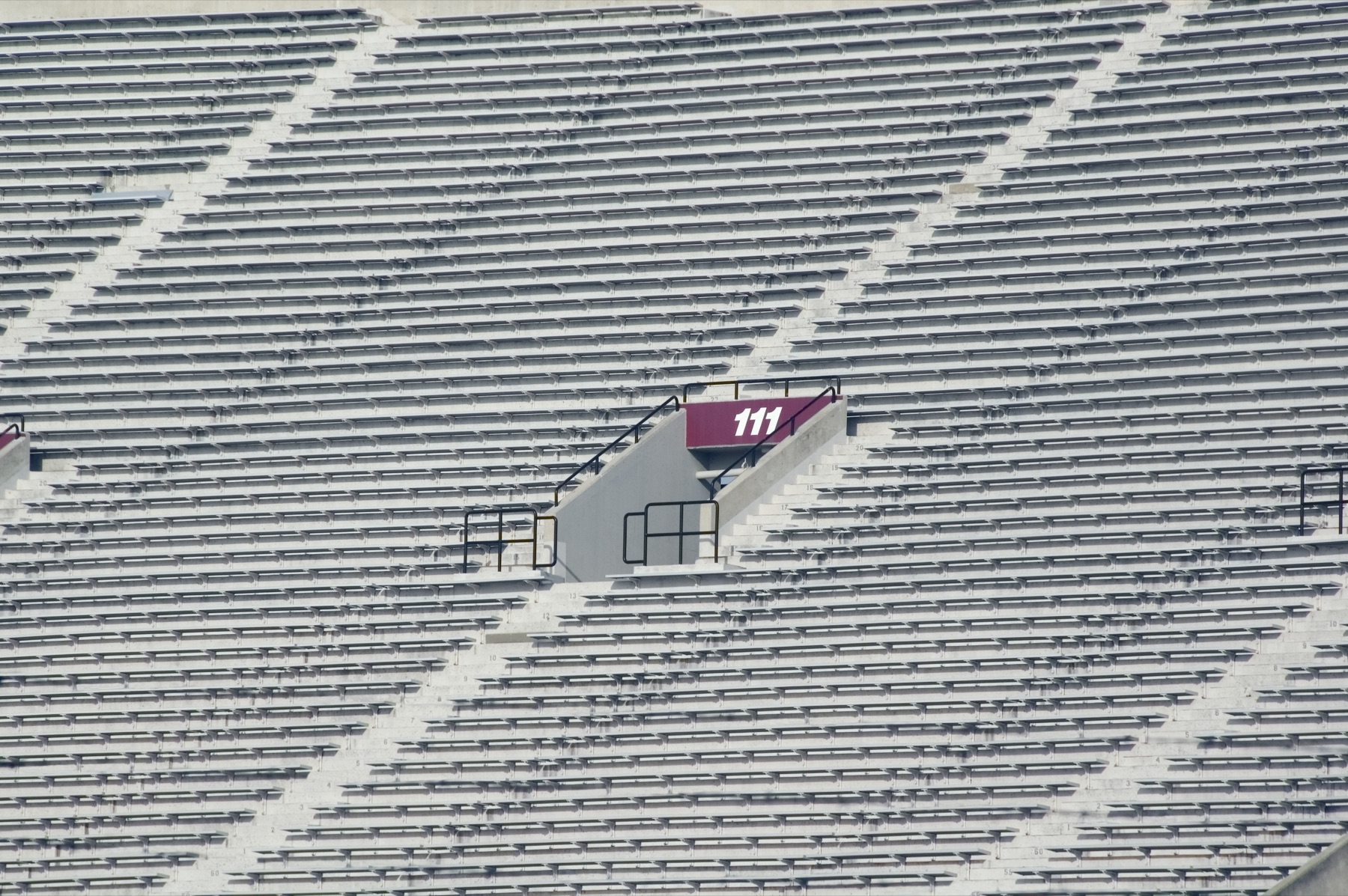 Empty college football stadium under a clear sky