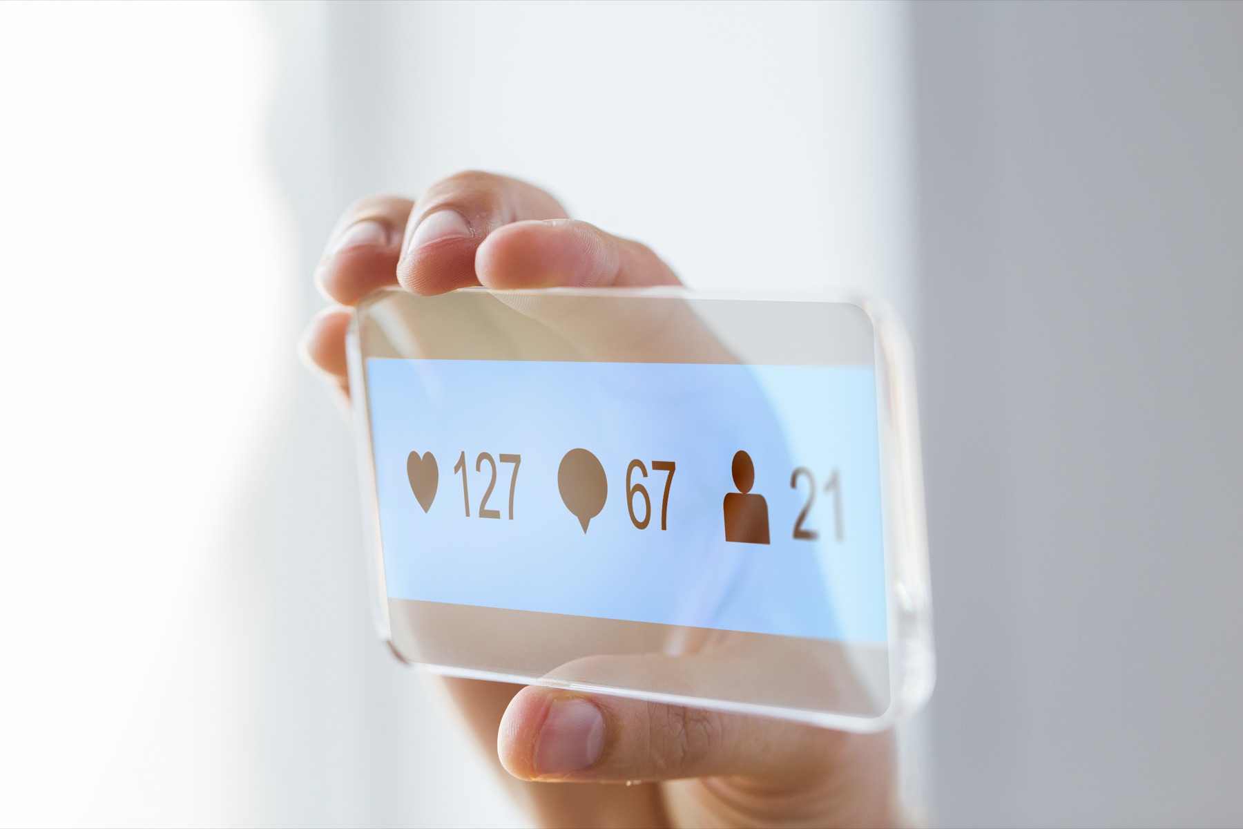 A smartphone displaying a social media feed with a sponsored advertisement