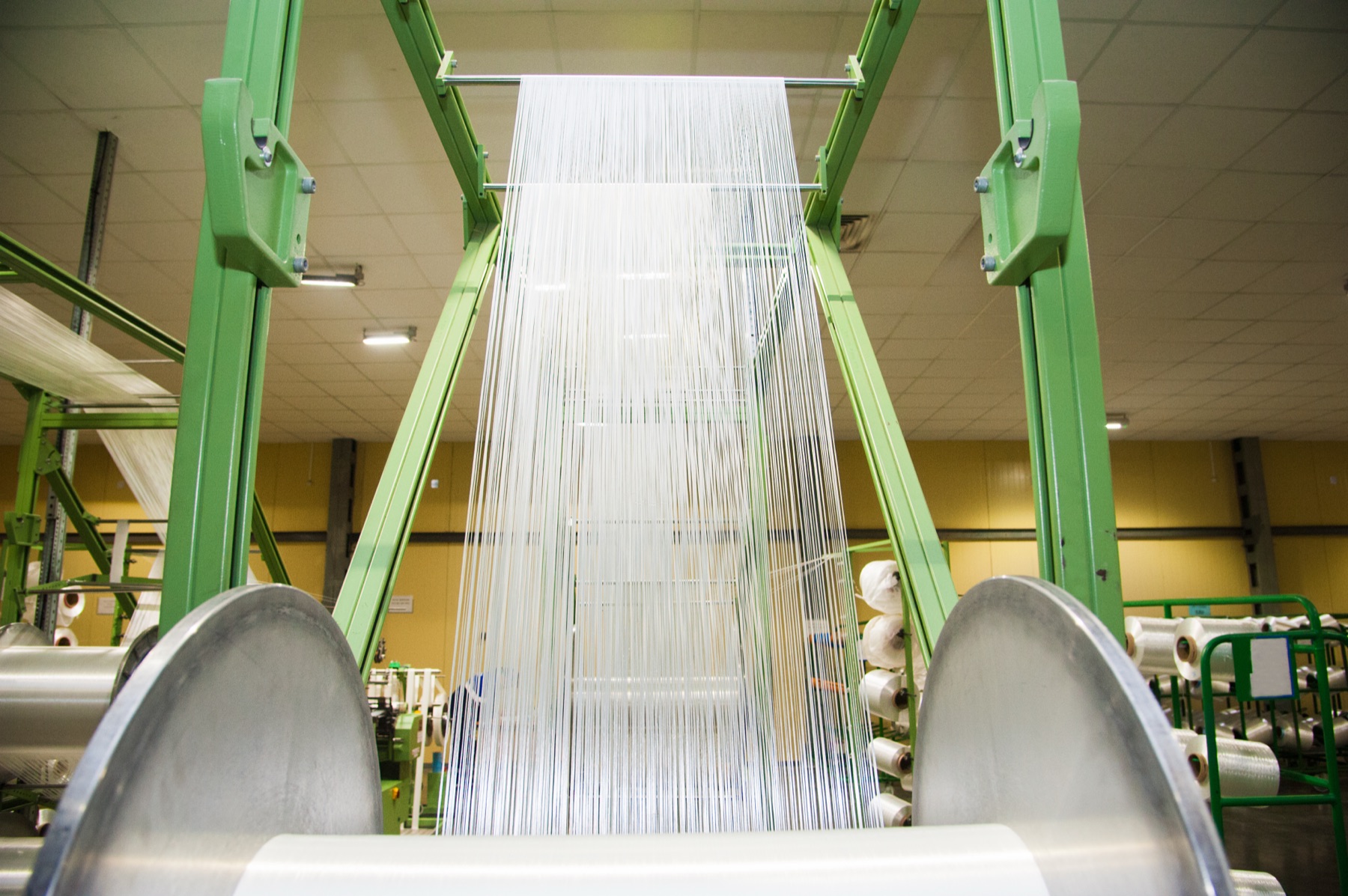 Spools of high-strength synthetic fiber on an industrial spinning line
