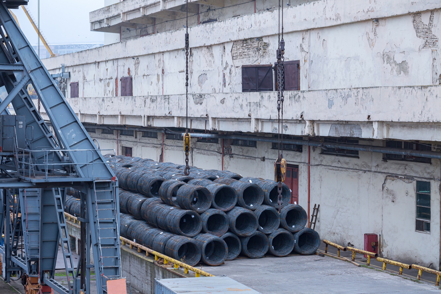 Cast steel railway wheels stacked at an industrial freight yard