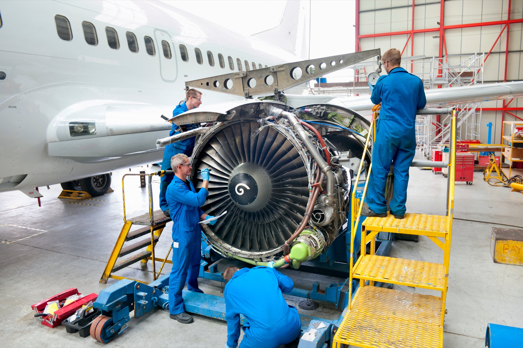 A turbine helicopter engine on a maintenance stand in a hangar