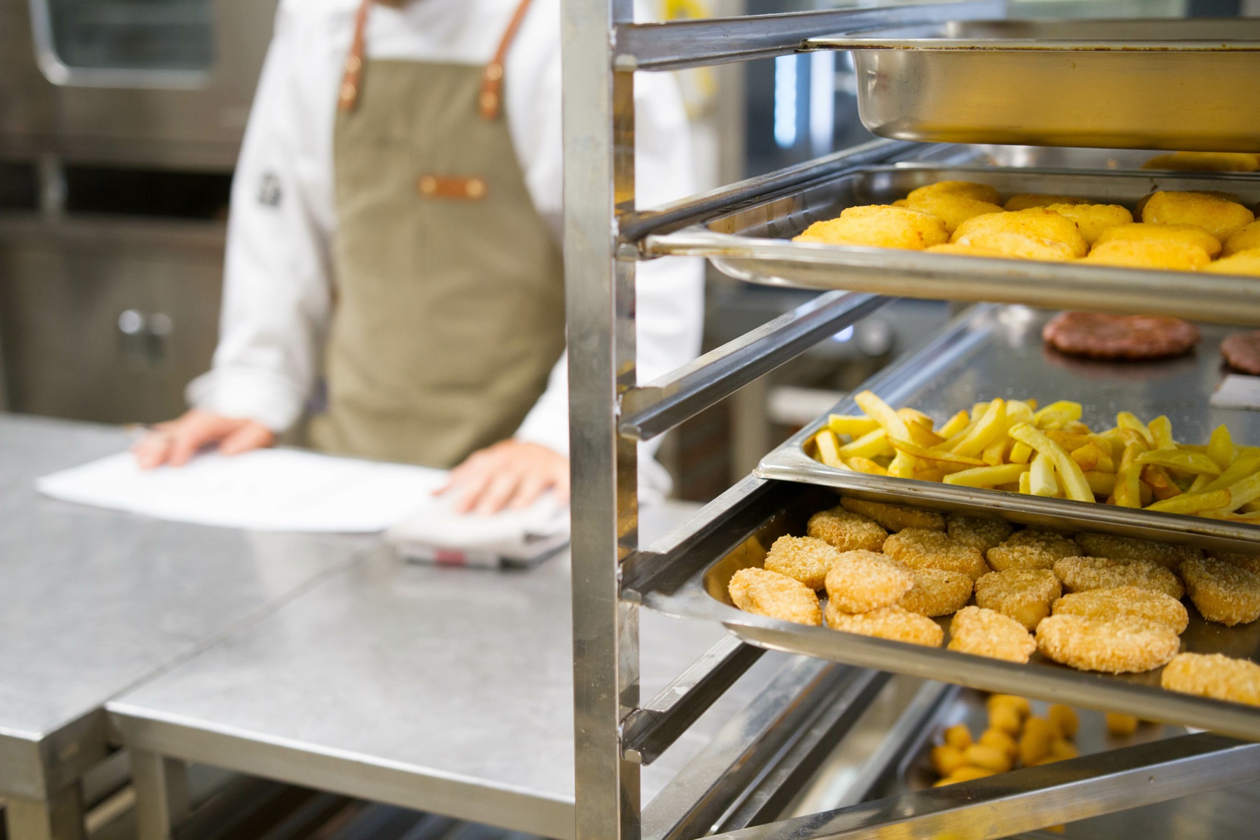 A restaurant buffet steam table lined with trays of prepared food