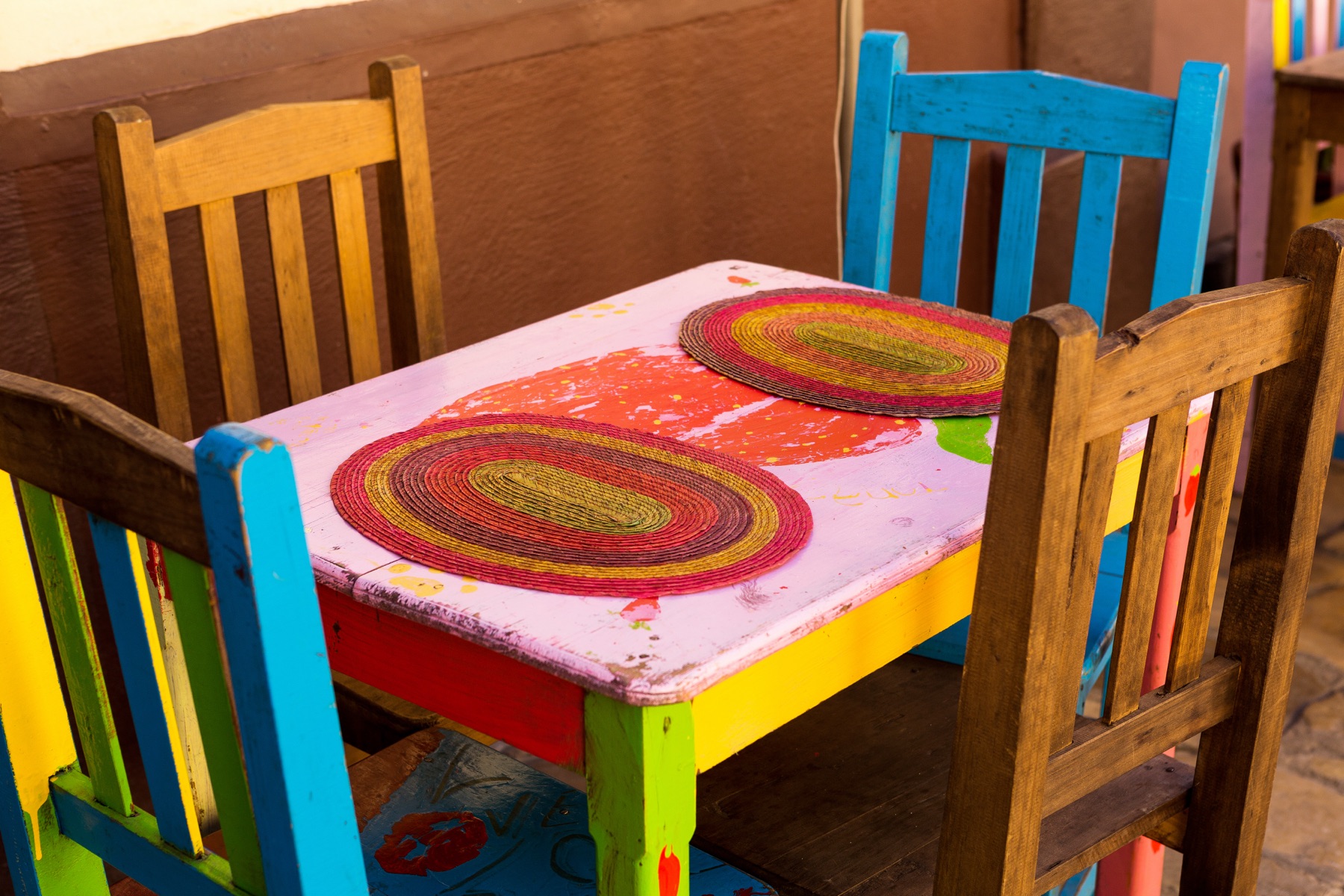 Brightly colored festive Mexican restaurant interior with patio and murals