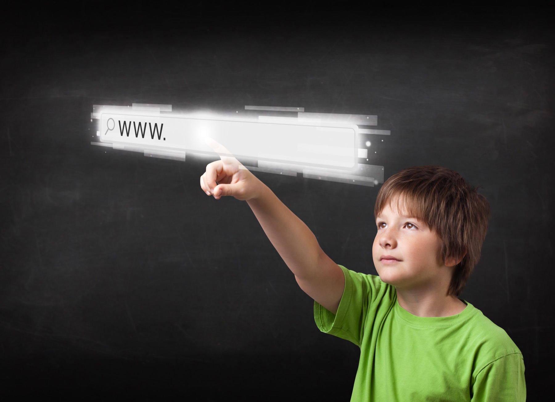 Hands typing a web address into a browser address bar on a laptop